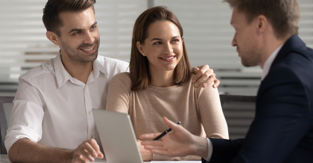 Smiling couple consulting with financial advisor about buyer supplier relationship management