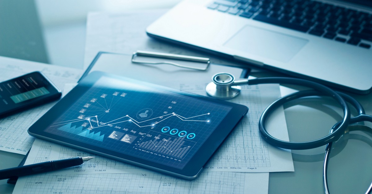 Healthcare business concept, Medical examination and graph data growth of business on tablet with doctor's health report clipboard on background.