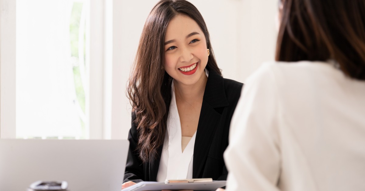 A young asian woman is interviewing for a job. Her interviewers are diverse. Human resources manager conducting job interview with applicants in office